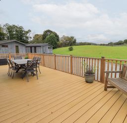 An outdoor deck with a table and chairs at Thie Loghey in Hawkshead