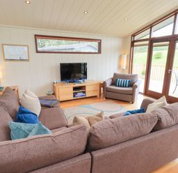 A living room with a television and sofa at Thie Loghey in Hawkshead