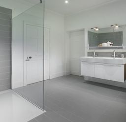 A bathroom with a double sink vanity mirror and toilet at Tent Lodge in Coniston