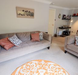 A living room with two sofas and a rug at Ghyll Heights in Ambleside