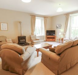 A living room with seating and a television at Hawkshead Hall in Hawkshead