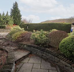 An outdoor area with a pathway and various bushes at Mardale in Ambleside