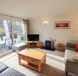 A living room with a television and sofa at Mardale in Ambleside