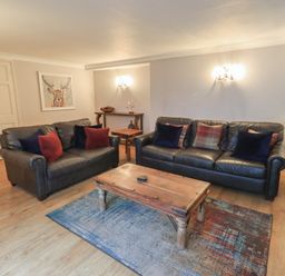 A living room with sofas and a coffee table at Chapel Hill Cottage in Ambleside