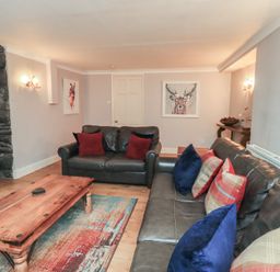 A living room with a sofa and coffee table at Chapel Hill Cottage Ambleside