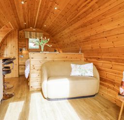 A bedroom with a sofa and kitchen counter at The Rhiw in Llanfair Caereinion