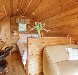 A bedroom with a bed and a small table at The Rhiw in Llanfair Caereinion