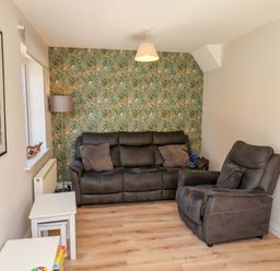 A living room with a sofa and chair at Driftwood in Filey