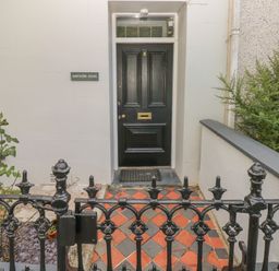 A black front door with the number 5 and a mail slot at Hawthorn House in Pembroke