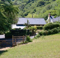 A rural property with houses surrounded by trees and greenery at Higher Bumsley Barn Parracombe