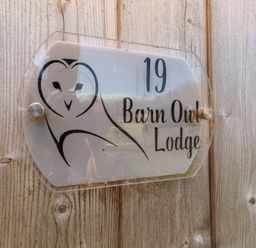 A sign with the number 19 and Barn Owl Lodge outdoors at Barn Owl Lodge in Otterburn