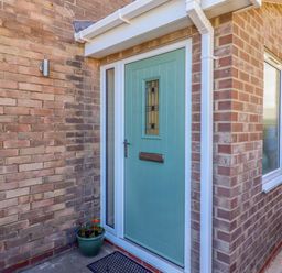 A front entrance with a door and plant pot at The Nest in Beadnell