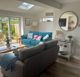 A living room with a sofa and coffee table at The Nest in Beadnell