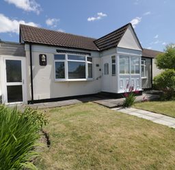 A bungalow with a front porch and garden pathway at Garden View in Quintrell Downs near Newquay