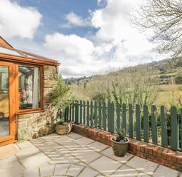 A conservatory with views of greenery at Calcott Annexe in Whitchurch, Herefordshire