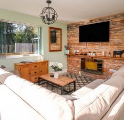 A living room with a sofa and coffee table at Bluebell Wood in Brandesburton