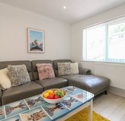 A living room with a sofa and a fruit bowl at Little Starboard in Kingsbridge