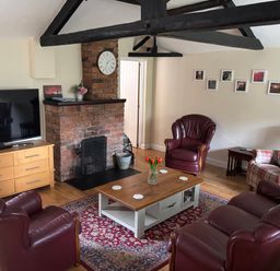 A living room with a television and a fireplace at Claire Cottage, Gateforth near Hambleton, North Yorkshire