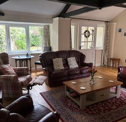A living room with sofas and a table at Claire Cottage near Hambleton, North Yorkshire