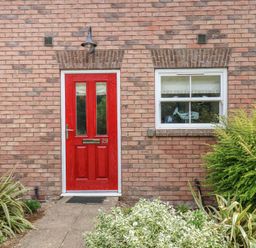 A red front door with a window next to it at Buck Place The Bay - Filey