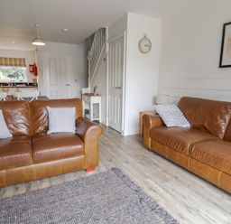 A living room with two sofas and a table at Buck Place The Bay - Filey