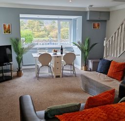 A living room with a dining area and sofa at Bryn in Bethesda