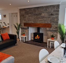 A living room with a fireplace and dining area at Bryn in Bethesda