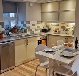 A kitchen with appliances and a dining table at Annest in Bethesda