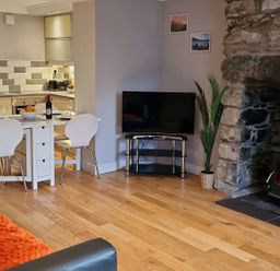 A living room with a dining area and fireplace at Annest in Bethesda