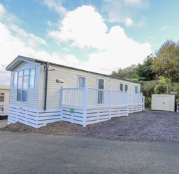 A mobile home with white railings and a small shed beside it at Ystwyth 26 in Borth