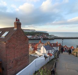 A coastal town with brick houses and stairs leading down to the harbor at Mariners Watch in Whitby