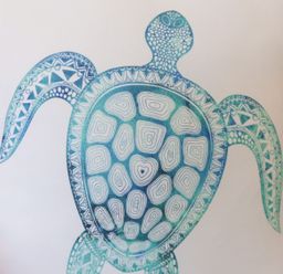 A cushion with a blue and white turtle design at Atlantis in St Ives