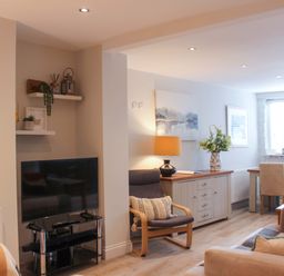 A living room with a television and dining area at Simples in Dartmouth