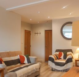 A living room with a sofa and armchair at Simples in Dartmouth
