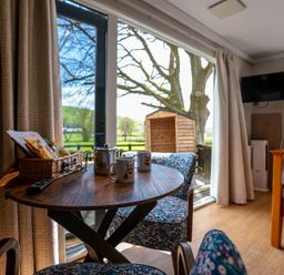 A living room with a table and chairs at The Fox Den in Nantmel near Rhayader