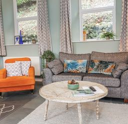 A living room with a sofa and armchair at Ferndale in Lynton