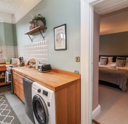 A kitchen with a washing machine and a countertop at Ferndale in Lynton
