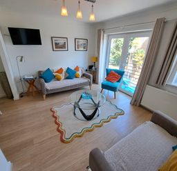 A living room with a coffee table and sofa at Castle Cove View in Castle Cove