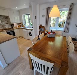 A kitchen with dining area at Castle Cove View in Castle Cove