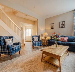 A living room with a sofa and armchairs at Home Farmhouse at the Graythwaite Estate near Hawkshead