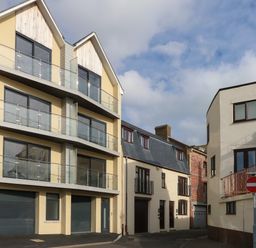 A street view with modern and traditional buildings and a no entry sign at Harbourside Haven Apartment 2 in Weymouth