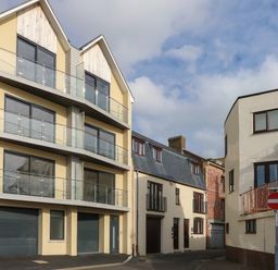 A street view with modern and older residential buildings and a no entry sign at Harbourside Haven Penthouse 2 Weymouth