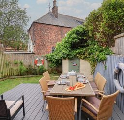 A garden with a table and chairs at Over Esk in Whitby