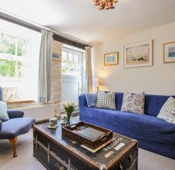 A living room with a sofa and armchair at 3 Rock Cottages Kingston