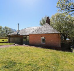 A house with a chimney in an outdoor area at Ardlochan Lodge - Culzean Castle in Maybole