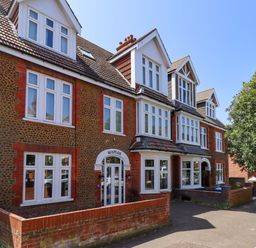 A building with multiple windows and a sign at Maples in Hunstanton