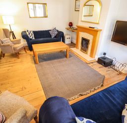A living room with a coffee table and fireplace at Maples in Hunstanton