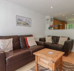 A living room with a coffee table and sofas at 49 Atlantic Reach in Newquay