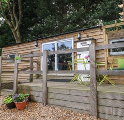 An outdoor area with seating and planters at Harvest Lodge in Wineham near Bolney