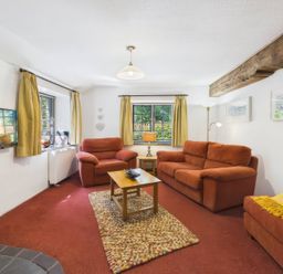 A living room with sofas and a coffee table at The Roundhouse in Warbstow